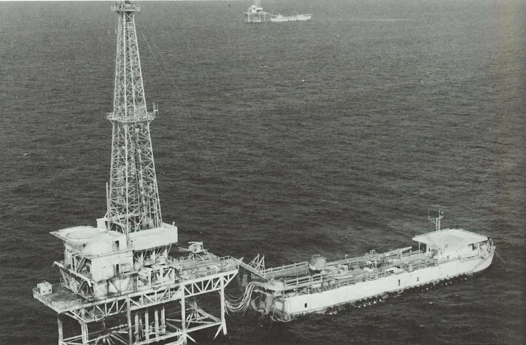 a - A tender-barge drilling rig